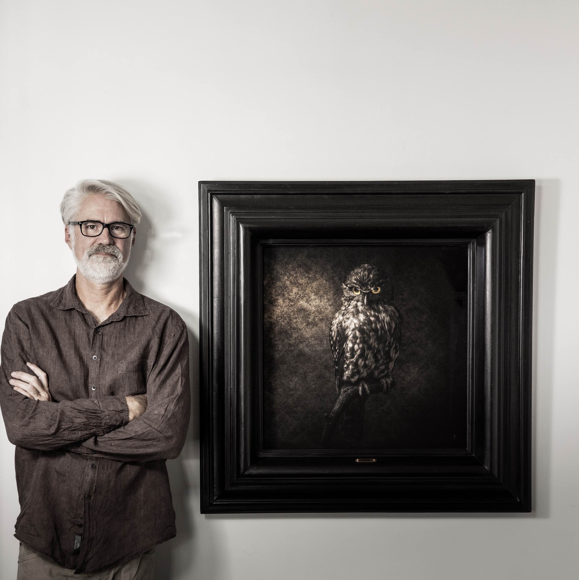 Artist Jae Frew with his Ruru photograph bird portrait Parnell Gallery Auckland NZ